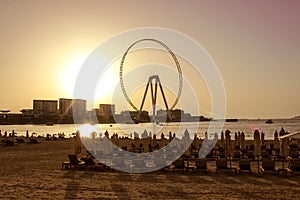 Sandy beach during sunset in the area of Dubai Marina.