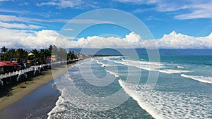 Sandy beach with tourists and surfers. Baler Philippines