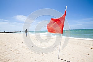 Sandy beach tropical sea with flag.