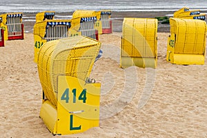 Sandy beach and typical hooded beach chairs in Cuxhaven in the North Sea coast