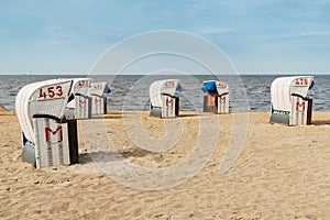 Sandy beach and typical hooded beach chairs in Cuxhaven in the North Sea coast