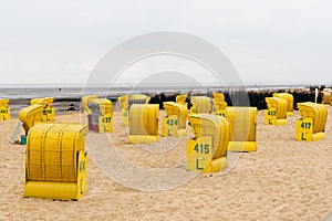 Sandy beach and typical hooded beach chairs in Cuxhaven in the North Sea coast