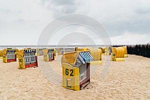 Sandy beach and typical hooded beach chairs in Cuxhaven in the North Sea coast