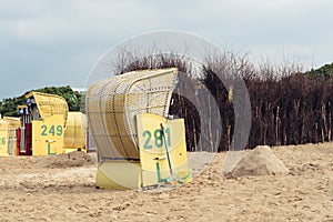 Sandy beach and typical hooded beach chairs in Cuxhaven in the North Sea coast