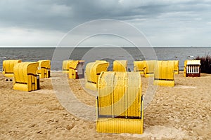 Sandy beach and typical hooded beach chairs in Cuxhaven in the North Sea coast