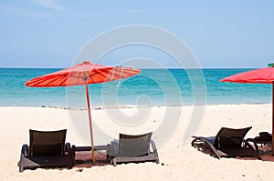 Sandy beach with umbrella and beach chair