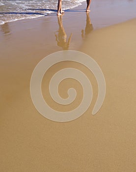 Sandy beach with walkers