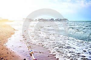 Sandy beach with waves from the sea.