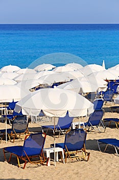 Sandy beach with white parasols and sunbeds