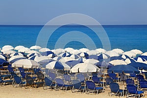 Sandy beach with white parasols and sunbeds