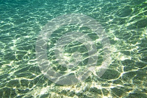 Sandy bottom with sunlight reflections