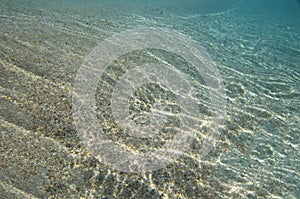 Sandy bottom with sunlight reflections