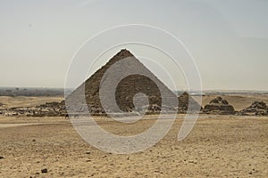 Sandy desert with Giza pyramids in the background