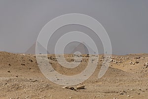 Sandy desert with Giza pyramids in the background