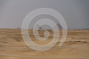 Sandy desert with Giza pyramids in the background