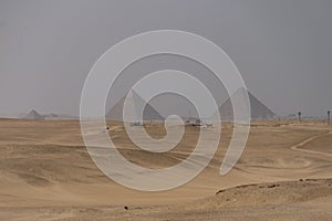 Sandy desert with Giza pyramids in the background