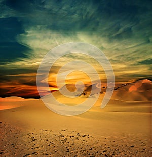 Sandy desert at sunset time photo