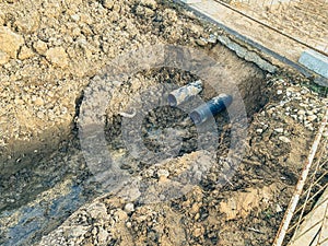 Sandy ditch with communications. in a new microdistrict of the city, pipes are being laid to bring communications to residential