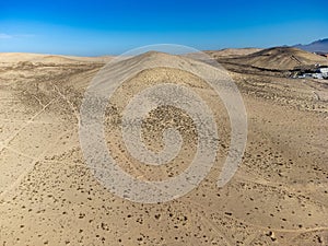 Sandy dunes and hills on Jandia peninsula near Playas de Sotavento en Costa Calma touristic resort, Fuerteventura, Canary islands