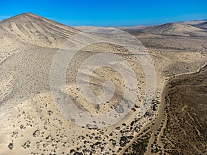 Sandy dunes and hills on Jandia peninsula near Playas de Sotavento en Costa Calma touristic resort, Fuerteventura, Canary islands