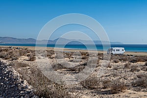 Sandy dunes and turquoise water of Sotavento beach, Costa Calma, Fuerteventura, Canary islands, Spain in winter, camper car