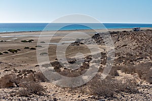 Sandy dunes and turquoise water of Sotavento beach, Costa Calma, Fuerteventura, Canary islands, Spain in winter, camper car