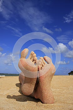 Sandy feet on a beach