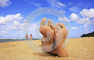 Sandy feet on a beach