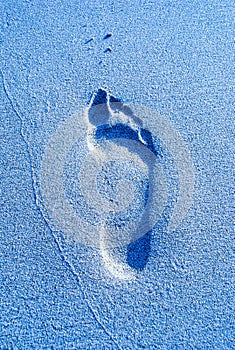 Blue footprint in the sand