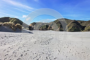 Sandy footsteps leading the way to Wharariki Beach