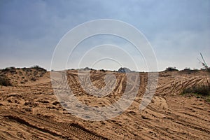 Sandy ground for cars 4x4 with traces of tires for cars