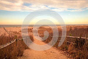 Sandy path leads to beach at Cape May meadows at sunrise on an early spring morning