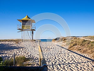 Sandy pathway entrance to the beach lifeguard tower, wooden rails Gold Coast Australia