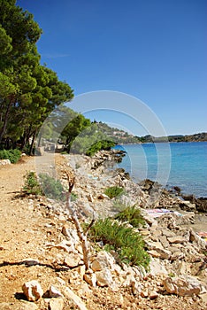 Sandy road along the beach and the sea