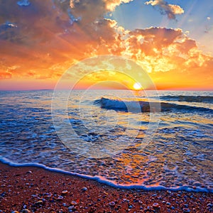 sandy sea beach at the dramatic sunset