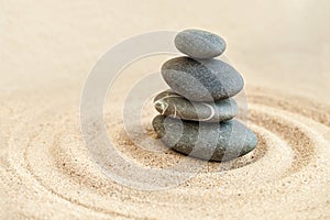 Sandy serenity. Shot of a stones stack in sand.