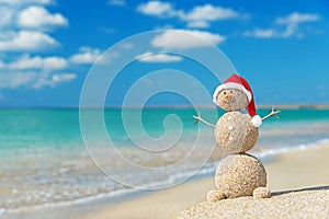 Sandy snowman in santa hat. Holiday concept for New Years and Ch