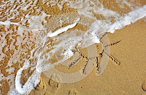 Sun drawing on a beach