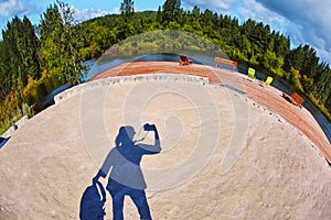 The sandy surface of the beach play area is formed by bright daylight, which falls under the shadow of the silhouette of the