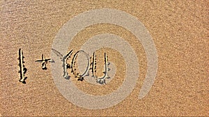 A sandy surface bears the inscription I + YOU, indicating a romantic sentiment