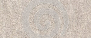 Sandy texture. Background of fine beige sand. Banner