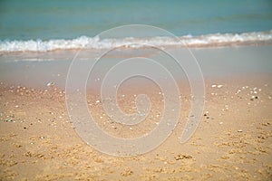 Sandy tropical beach with blur waves at the background