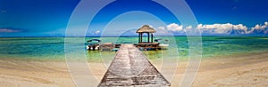 Sandy tropical beach. Jetty on the foreground. Panorama