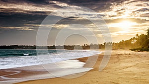 Sandy tropical beach at sunset