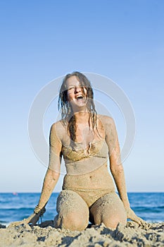 Sandy woman at the beach