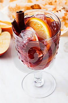 Sangria in a glass ice orange apple cinnamon on top cold wine