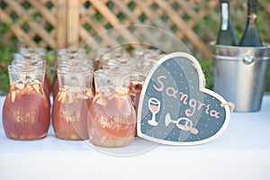 Sangria in jugs await guests at a wedding reception