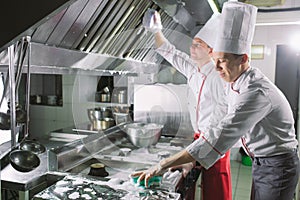 Sanitary day in the restaurant. Repeats wash your workplace. Cooks wash oven, stove and extractor in the Restaurant.