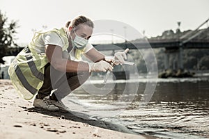 Sanitary inspector holding test tubes while checking water contamination level