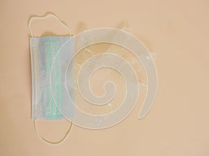 Sanitary mask with plastic glove on cream with copy